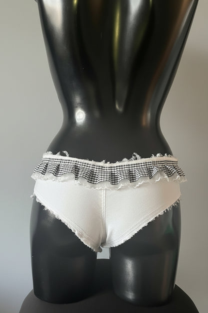 Gang of Divas White low-rise denim briefs with a black and white gingham ruffle waistband.